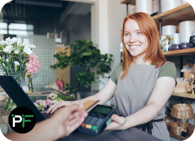 An employee processing a card transaction at checkout, representing the efficiency and security of modern ecommerce software development.