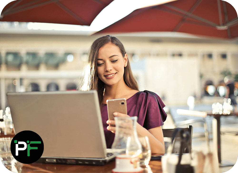 A happy user reviewing data on a laptop, showcasing the seamless integration and productivity benefits of Power Apps Solutions