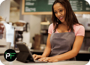 A retail professional using a tablet for business operations, illustrating the convenience and effectiveness of retail software development services.