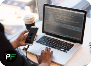 A developer working across multiple devices, coding and integrating various digital tools, representing comprehensive technology stack solutions.