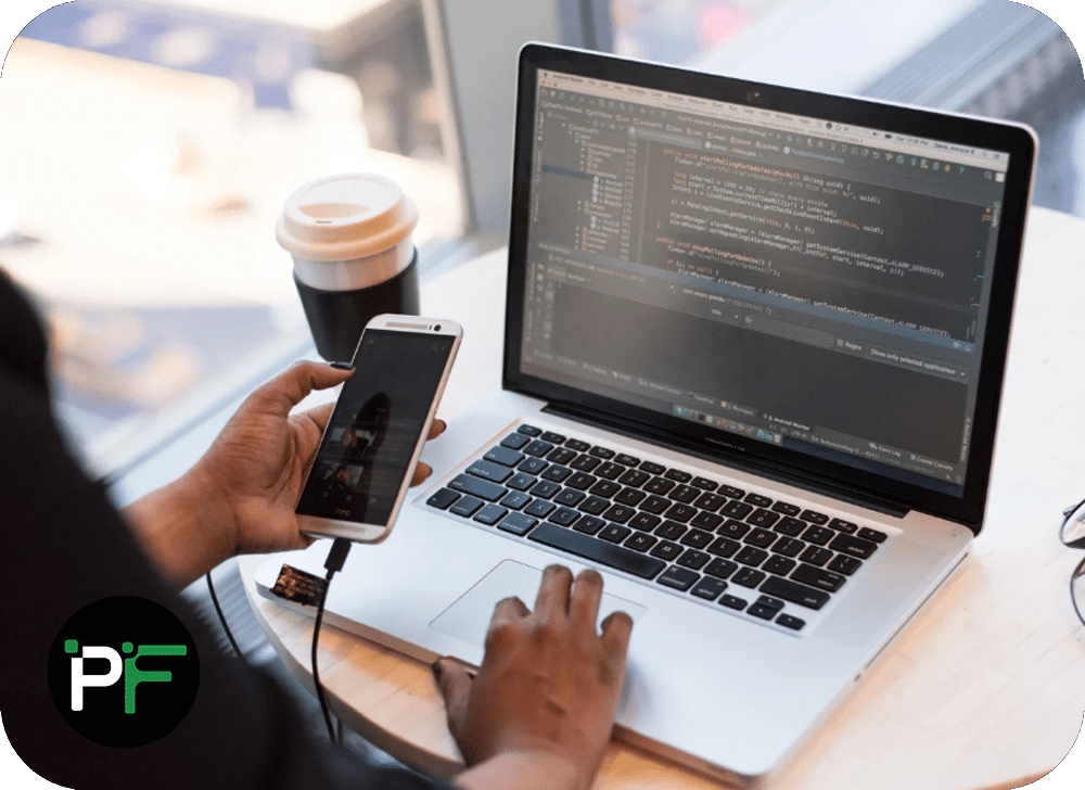 A developer working across multiple devices, coding and integrating various digital tools, representing comprehensive technology stack solutions.