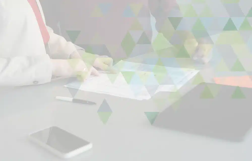 Two people working through paperwork by hand