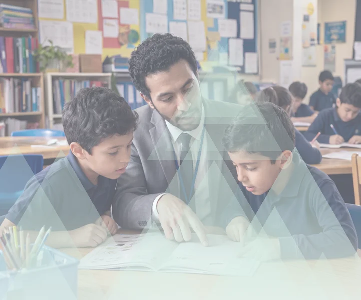 Teacher helping two pupils with their reading in a classroom